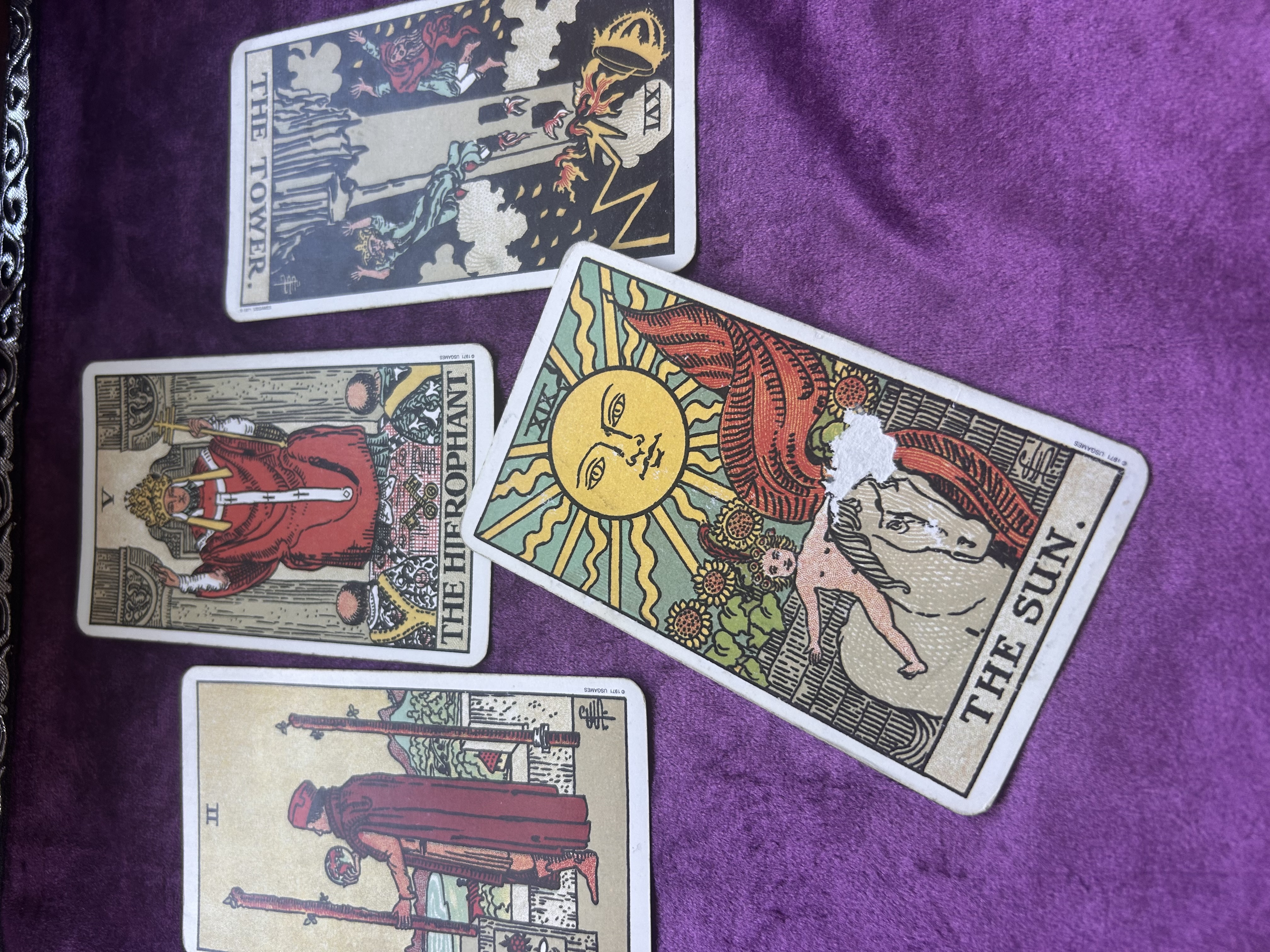 Tarot card spread showing The Hierophant, The Sun and The Lovers
