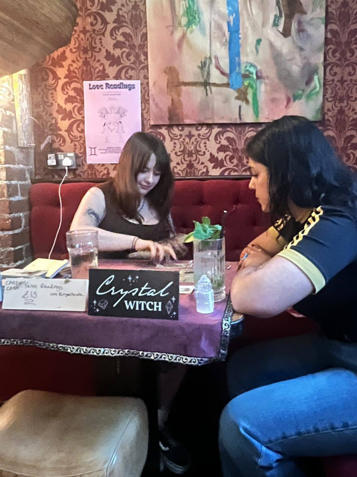 Crystal the Witch conducting a tarot reading with a client